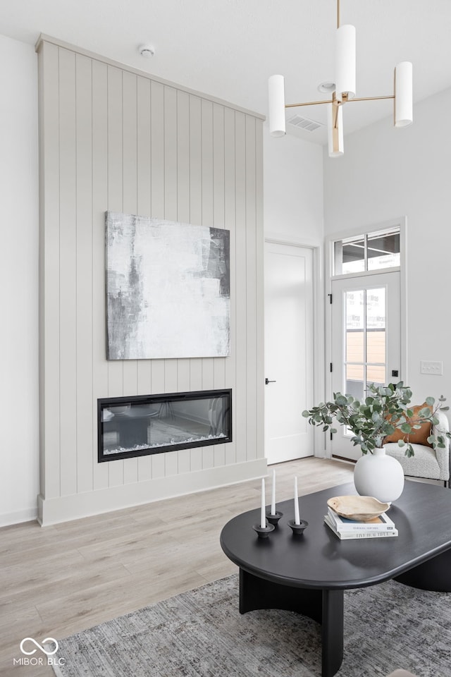 living room featuring ceiling fan and light hardwood / wood-style flooring