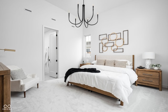 bedroom with light carpet, a towering ceiling, and an inviting chandelier