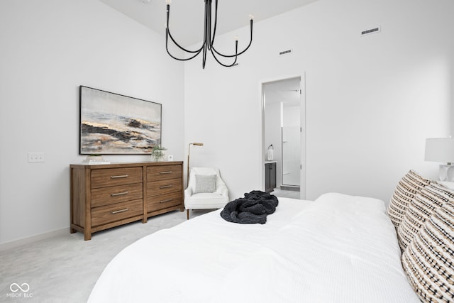 carpeted bedroom featuring a high ceiling, an inviting chandelier, and ensuite bath