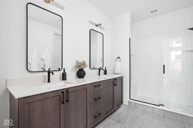 bathroom with tile patterned floors, vanity, and a shower with shower door