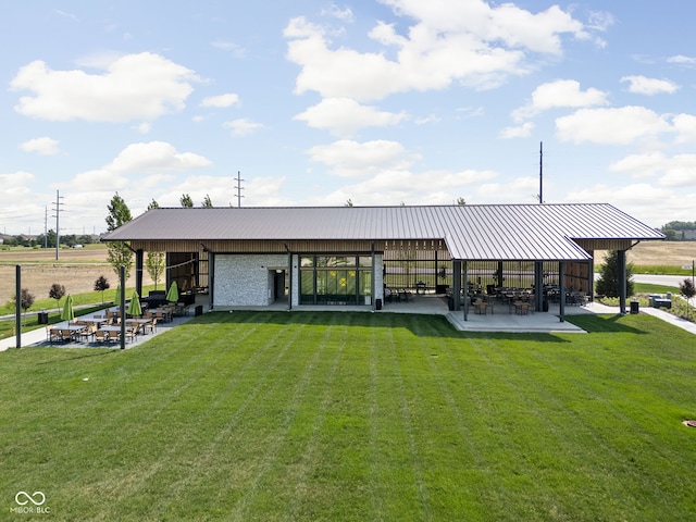 view of property's community featuring a patio and a lawn