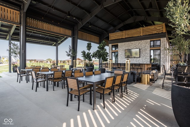 view of patio / terrace with exterior bar, a gazebo, and an outdoor stone fireplace