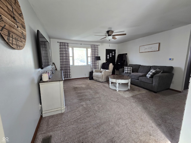 carpeted living room with ceiling fan