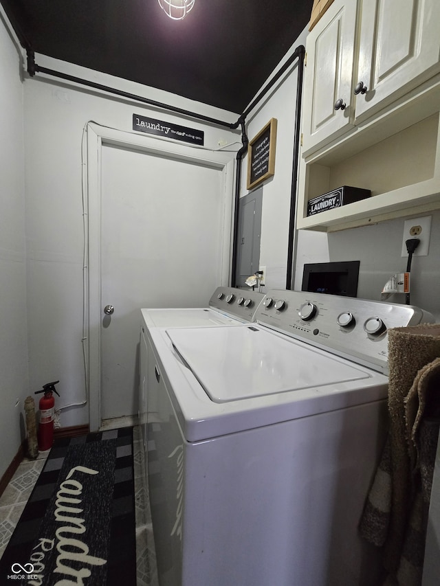 washroom featuring cabinets, electric panel, and washing machine and dryer