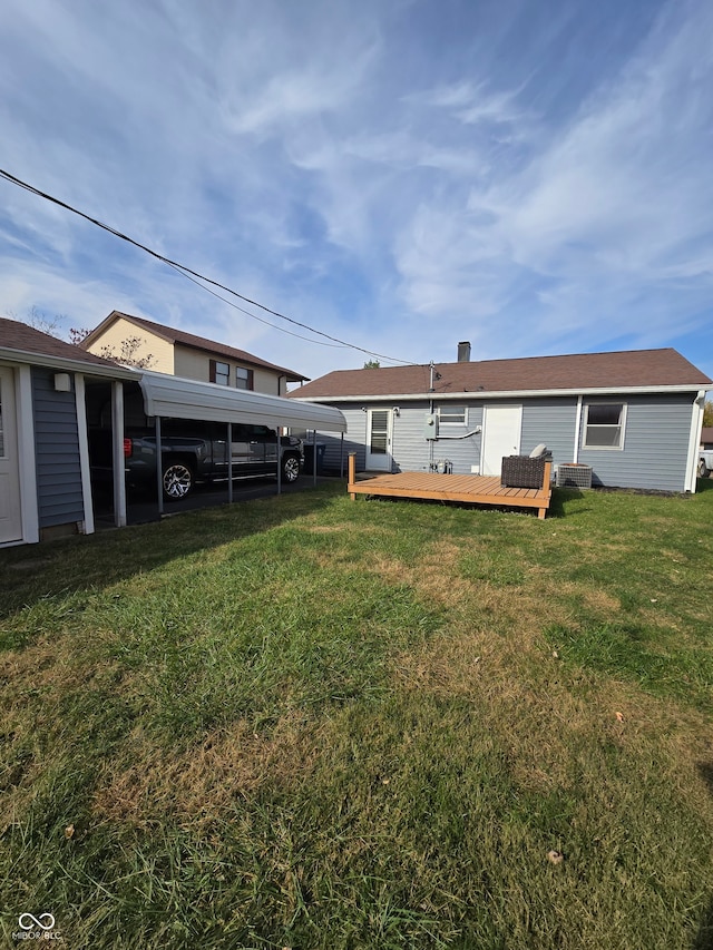 view of yard featuring cooling unit, a deck, and a carport