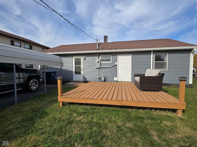 rear view of property with a deck and a lawn