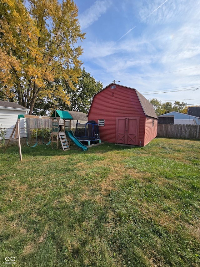 view of yard with a storage unit and a playground