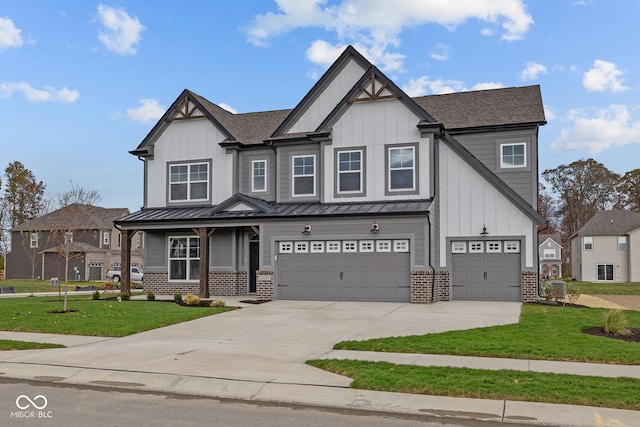 craftsman house with a garage and a front lawn