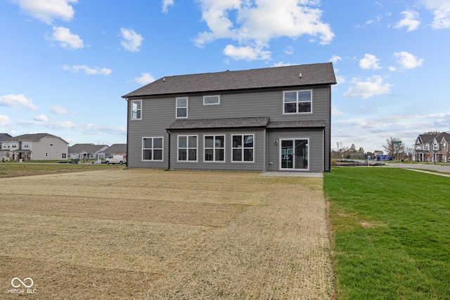 back of house featuring a yard