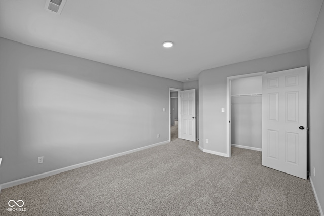 unfurnished bedroom with a closet and carpet flooring