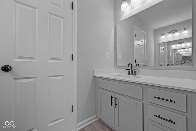 bathroom with hardwood / wood-style floors and vanity