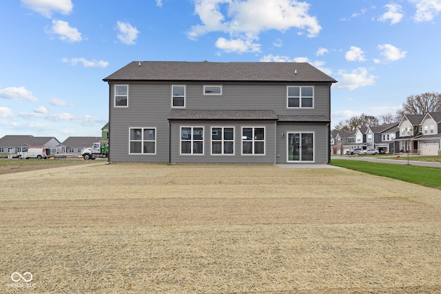 rear view of property with a lawn