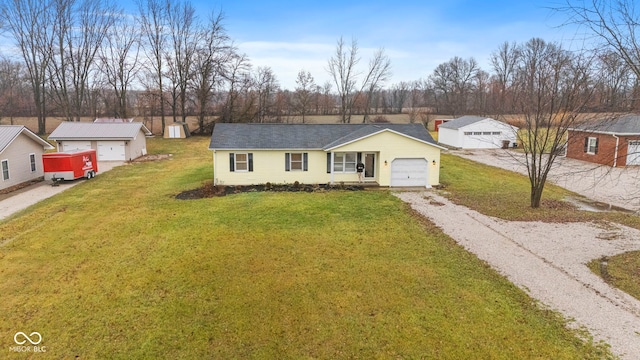 single story home with an outdoor structure, a front yard, and a garage