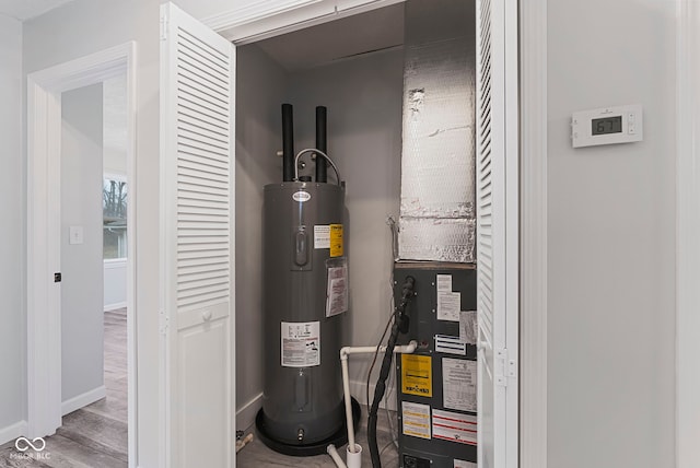 utility room featuring water heater