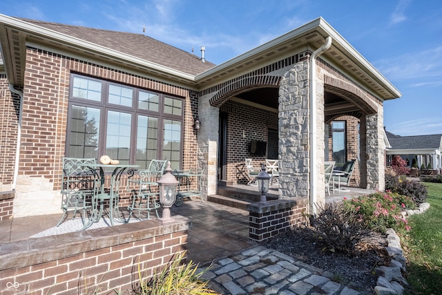 rear view of property with covered porch