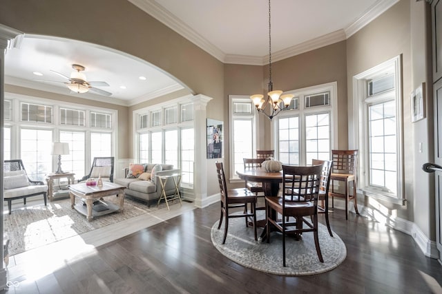 dining area featuring crown molding, ceiling fan with notable chandelier, and dark hardwood / wood-style floors