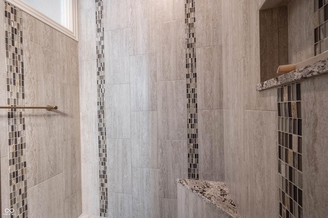 bathroom with tiled shower