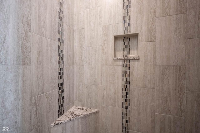 interior details with a tile shower