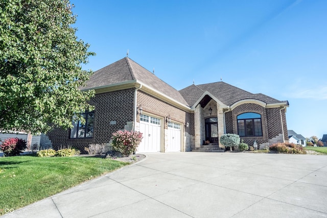 view of front of home featuring a garage and a front lawn