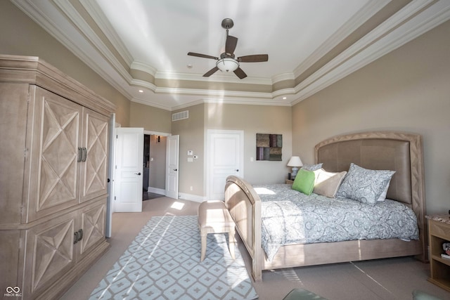 bedroom with light carpet, a tray ceiling, ornamental molding, and ceiling fan