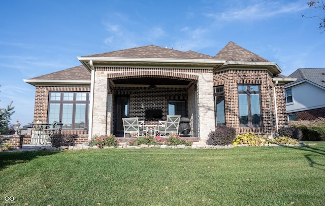 rear view of property with a yard