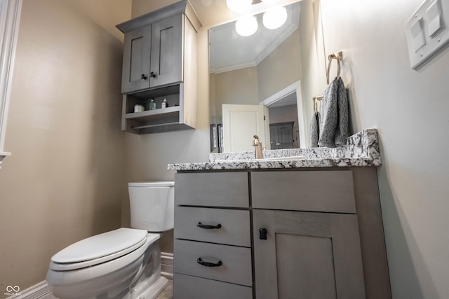 bathroom featuring ornamental molding, vanity, and toilet