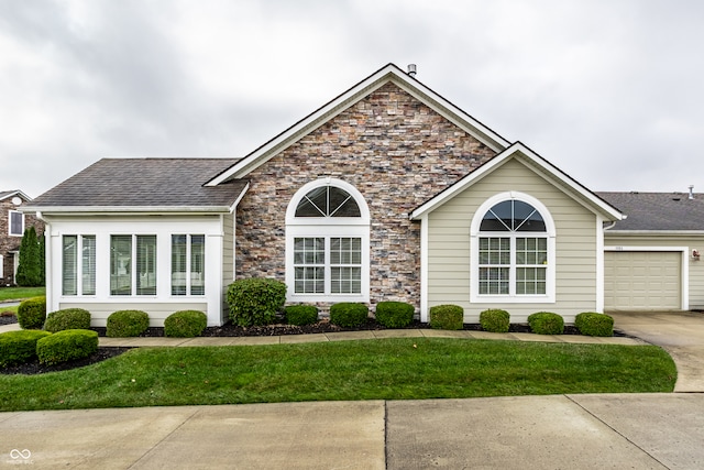 ranch-style house featuring a garage and a front lawn