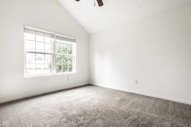 carpeted empty room with ceiling fan and high vaulted ceiling