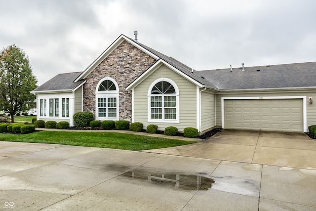 single story home featuring a front lawn and a garage