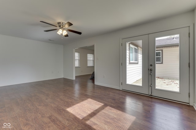 empty room with french doors, dark hardwood / wood-style floors, and ceiling fan