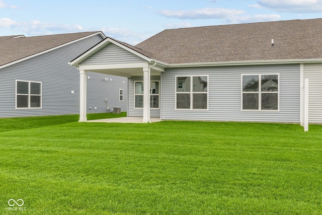 back of house featuring a patio area and a yard