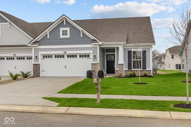 craftsman-style home featuring a front yard and a garage