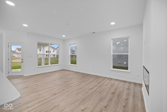 unfurnished living room featuring light wood-type flooring