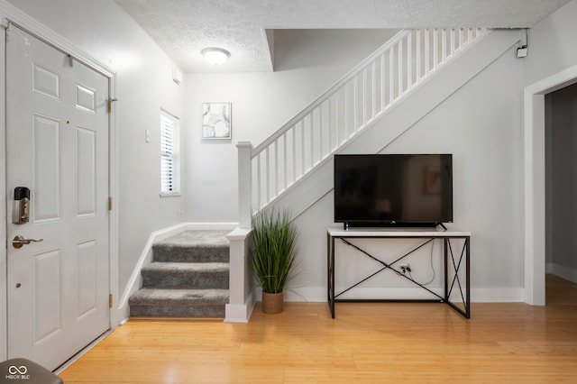 entrance foyer featuring wood-type flooring and a textured ceiling