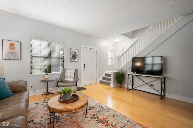 living room featuring a textured ceiling and hardwood / wood-style flooring