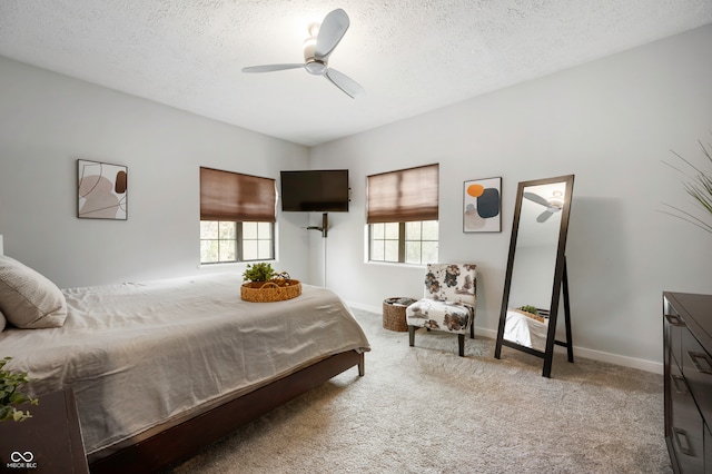 carpeted bedroom with a textured ceiling and ceiling fan