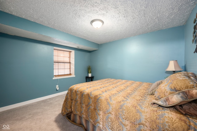 bedroom featuring a textured ceiling and carpet