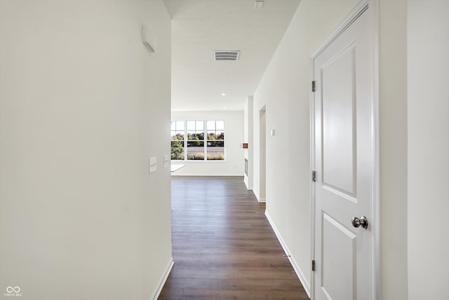 hallway with dark hardwood / wood-style floors