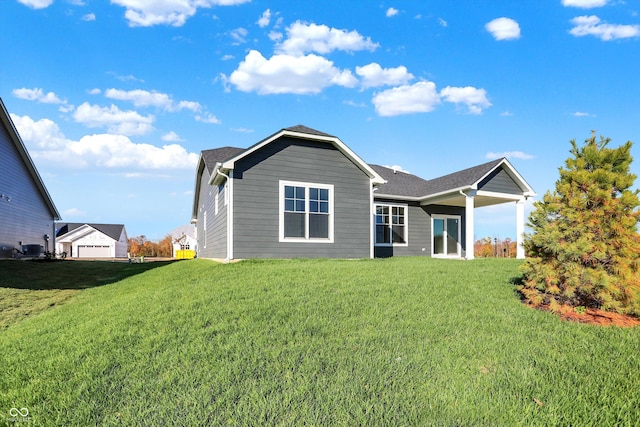 rear view of house featuring a yard