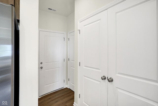 hall featuring visible vents and dark wood-style floors