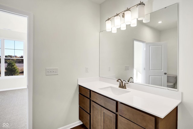 bathroom with toilet and vanity