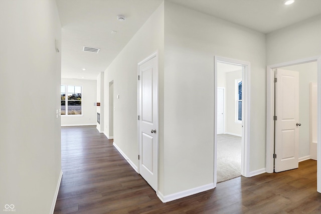 hallway featuring baseboards, dark wood-type flooring, recessed lighting, and visible vents