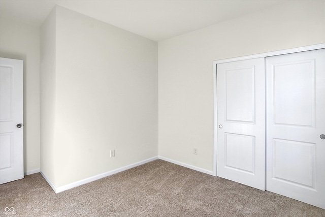 unfurnished bedroom with a closet and carpet