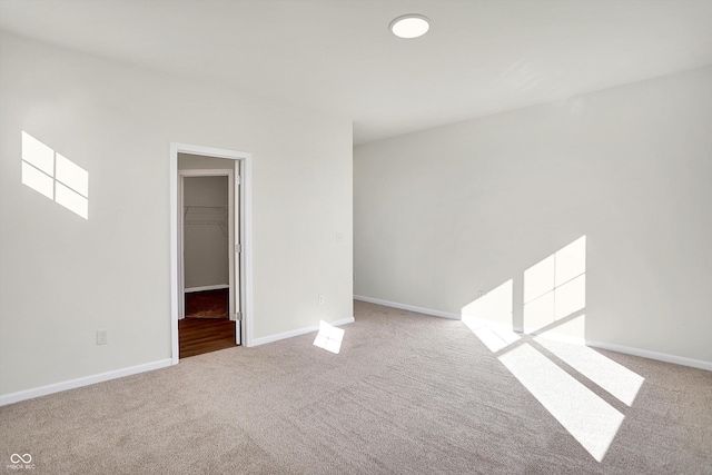 empty room with carpet flooring and baseboards