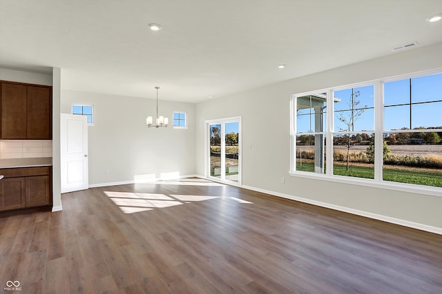 interior space featuring an inviting chandelier and hardwood / wood-style floors