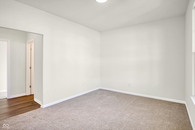 spare room with dark wood-type flooring