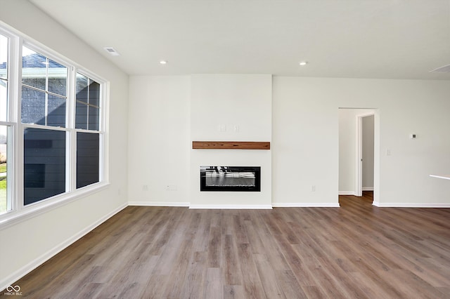 unfurnished living room with light hardwood / wood-style flooring