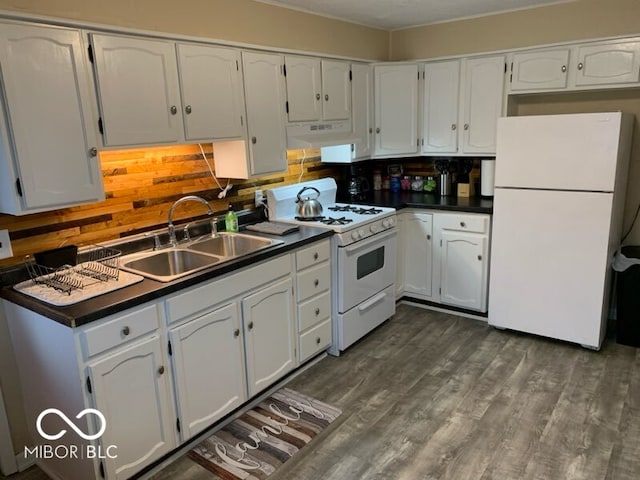 kitchen with backsplash, sink, white cabinetry, white appliances, and dark hardwood / wood-style flooring