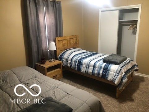 carpeted bedroom featuring a closet