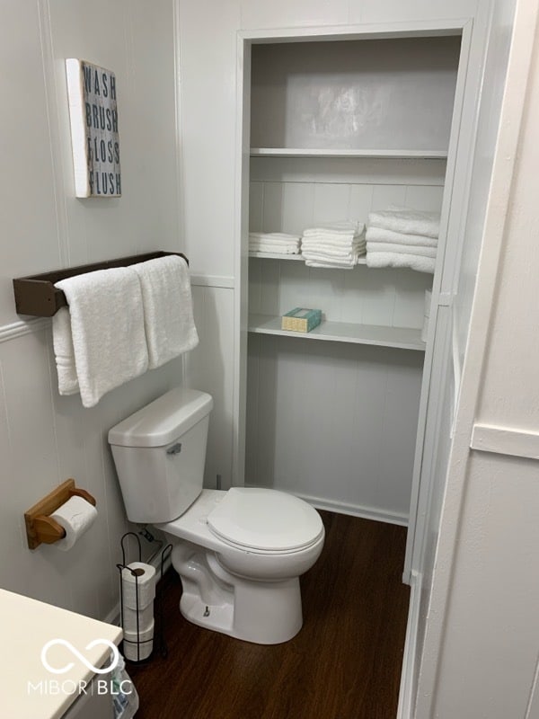 bathroom with hardwood / wood-style floors and toilet